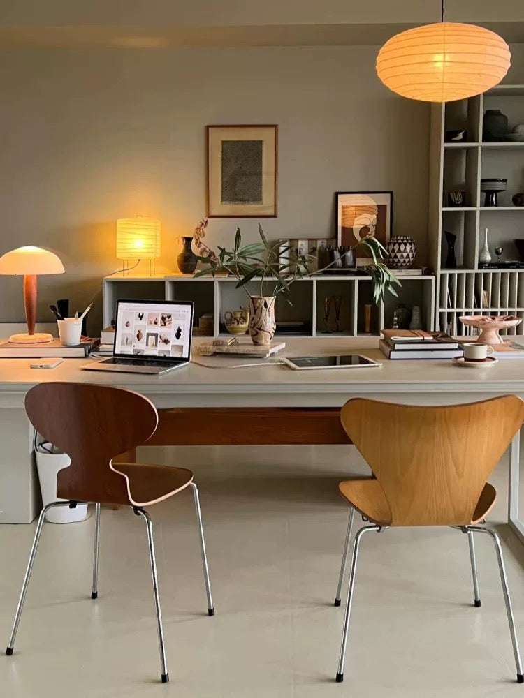 Modern office space with a desk, chairs, and decorative items.