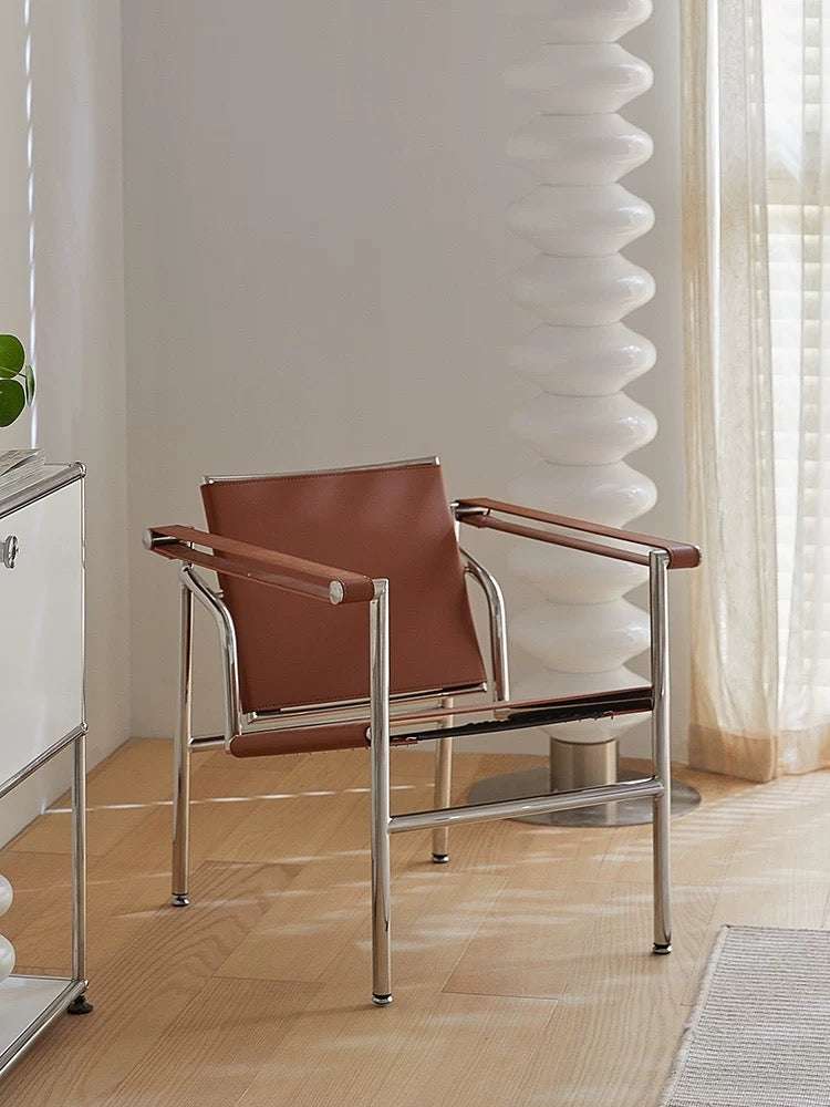 Brown chair with metal frame in a room with light-colored walls and wooden floor.