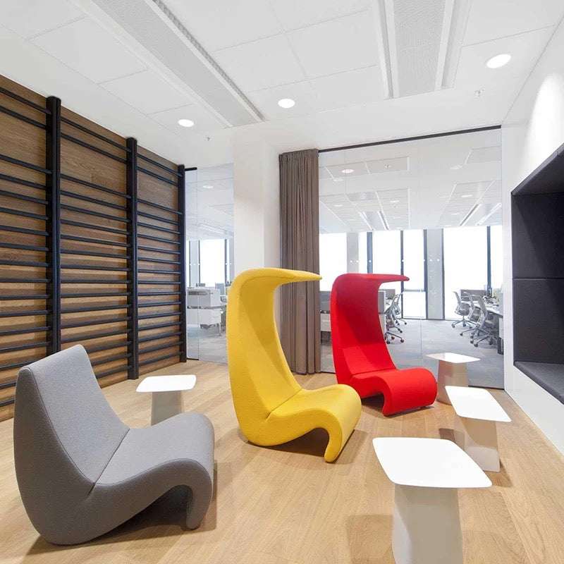Modern office space with colorful chairs and tables.