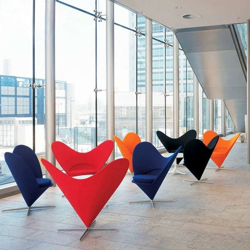 Colorful modern chairs in a modern office setting with large windows.