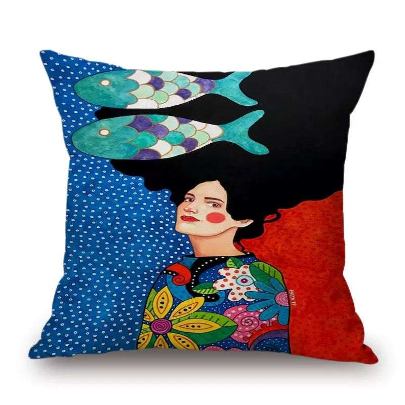 Colorful pillow with a design of a woman with fish on her head against a blue and red background.