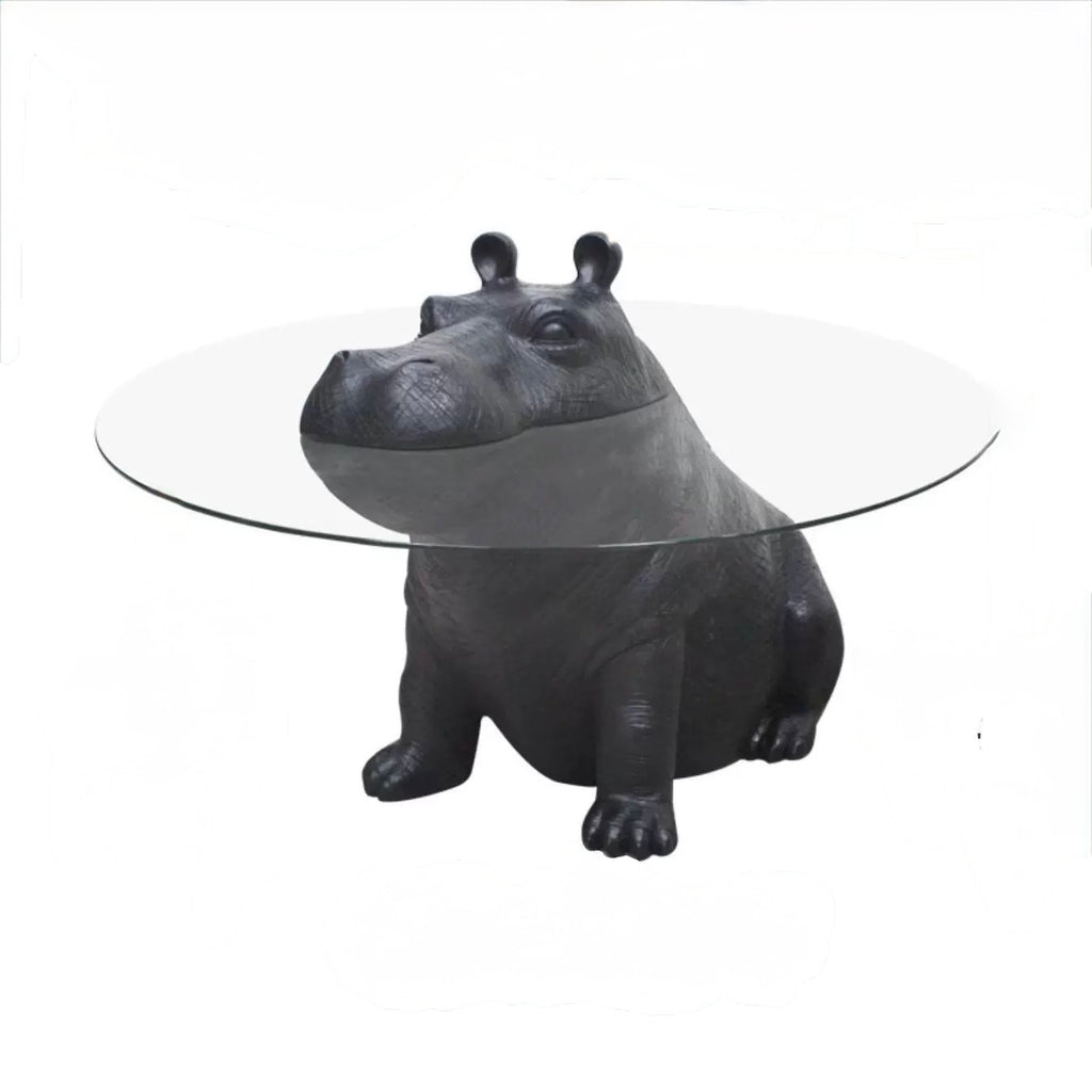 Hippo-shaped table with a clear glass top on a white background