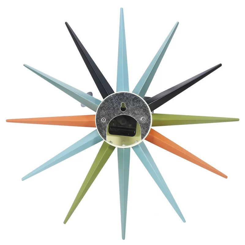Decorative wall clock with multicolored spiky design on a white background