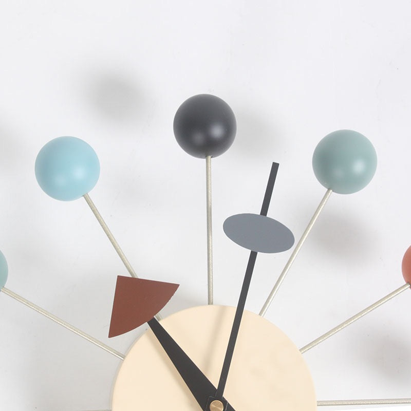 Modern wall clock with colorful geometric design on a white background