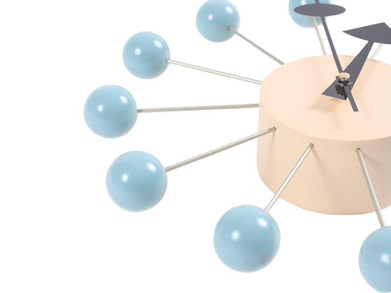 Modern wall clock with blue spherical design on a white background