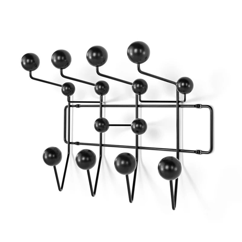Black wall-mounted coat rack with round hooks on a white background