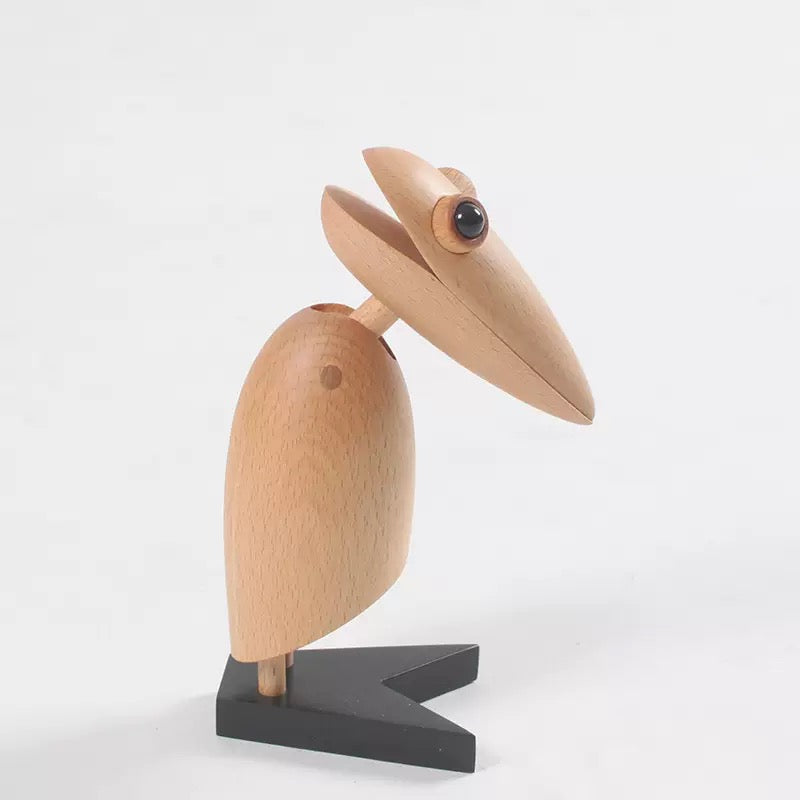 Wooden pelican figurine on a white background