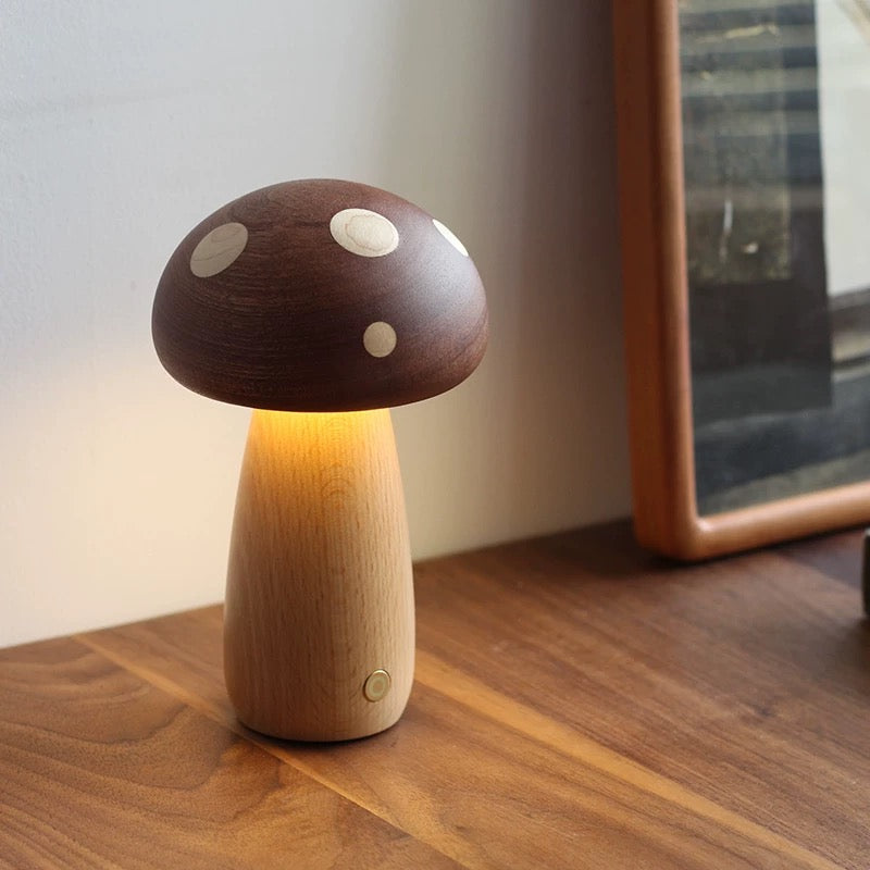 Wooden mushroom-shaped lamp on a wooden surface with a blurred background
