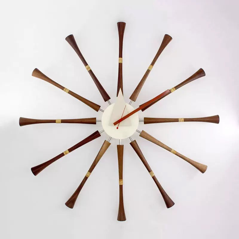 Decorative wall clock with wooden arms on a white background