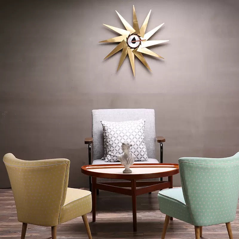 Three chairs in a room with a decorative wall clock.