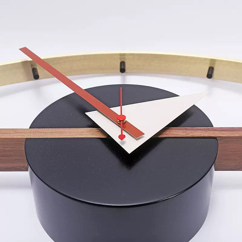 Modern wall clock with black face, red hands, and wooden accents on a white background