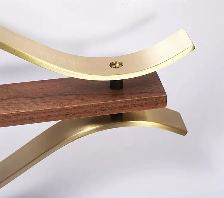 Wooden stool with gold metal legs on a white background