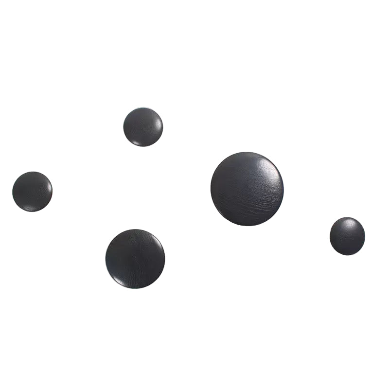 Set of five black round objects on a white background