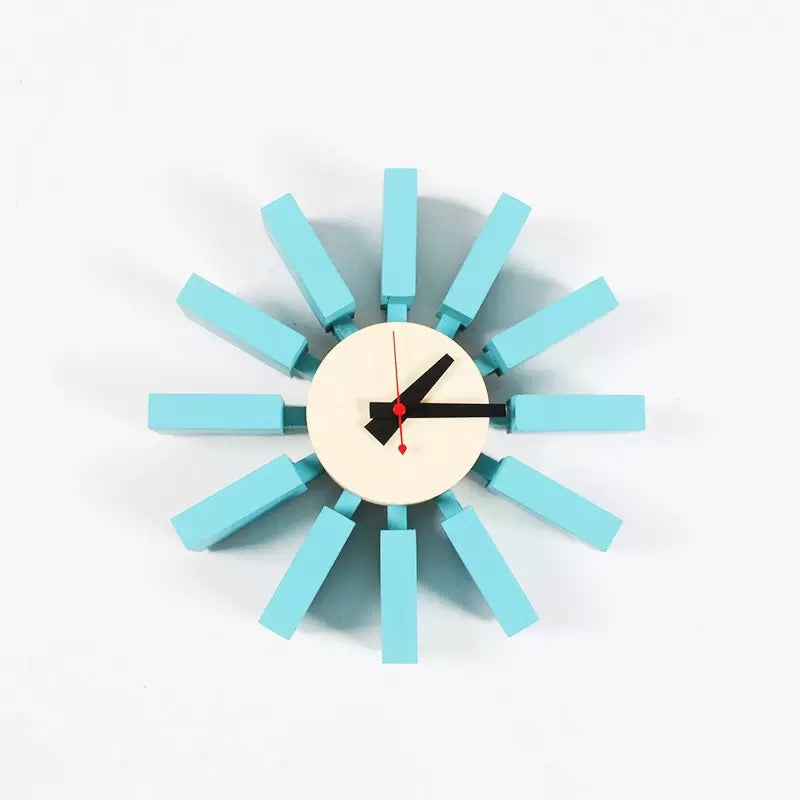 Modern wall clock with turquoise wooden accents on a white background