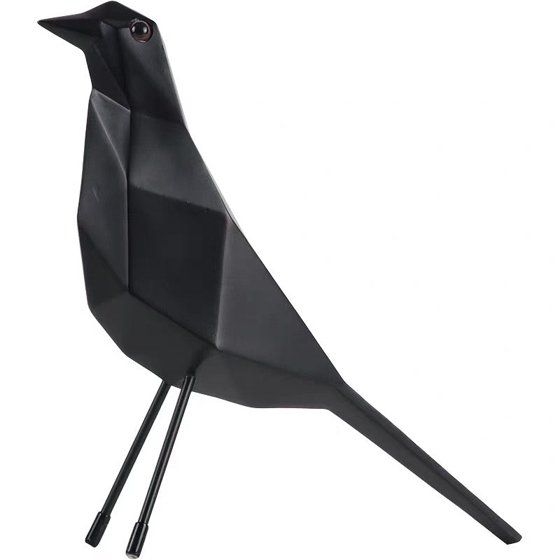 Black geometric bird sculpture on a white background