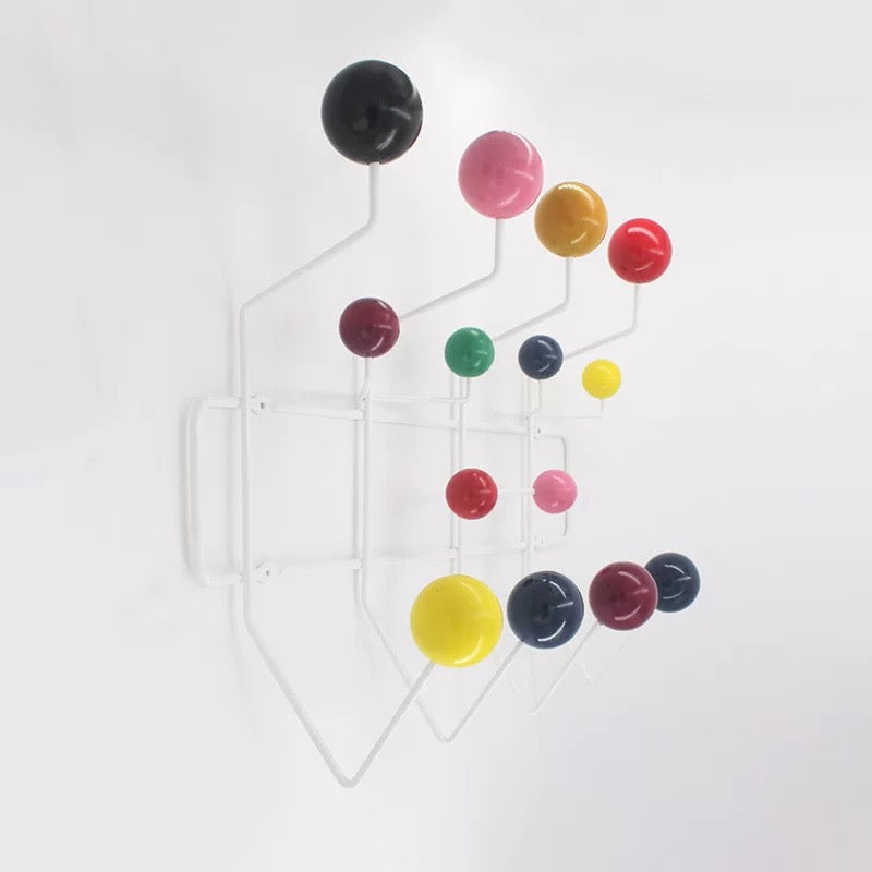 Colorful round hooks on a white wall
