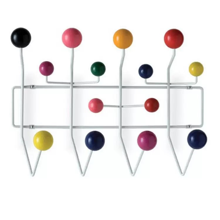 Wall-mounted coat rack with colorful hooks on a white background
