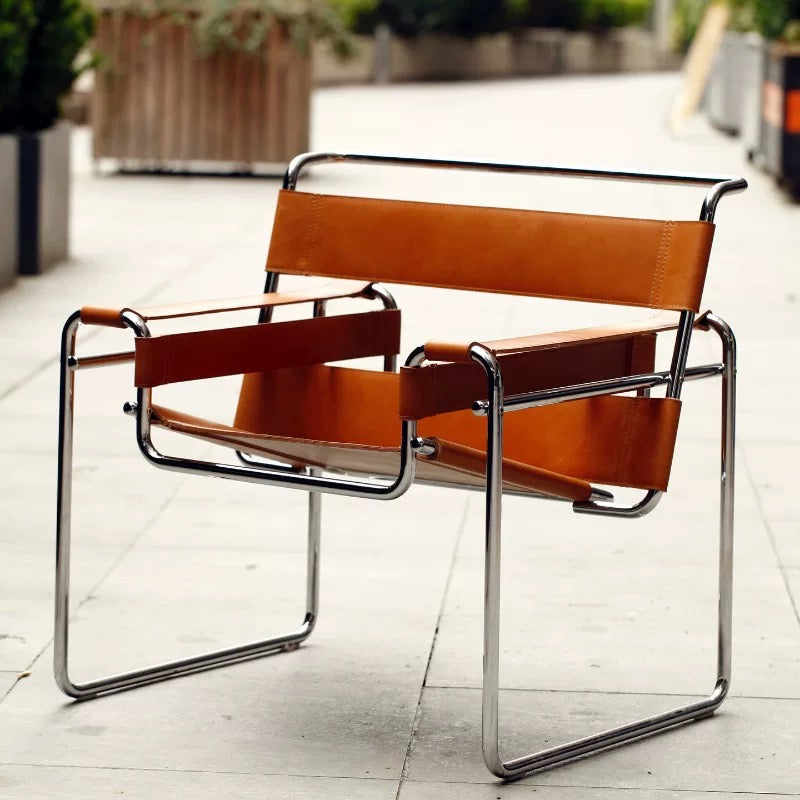 Brown leather chair with metal frame on a light wooden floor