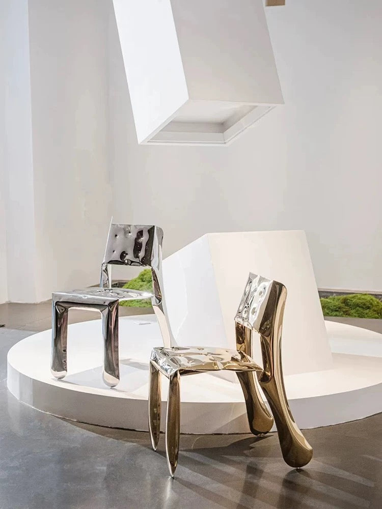 Two modern chairs on a round platform with a neutral background