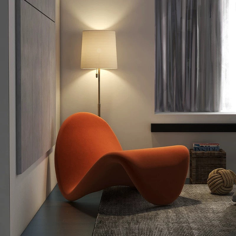 Orange chair in a room with a lamp and window