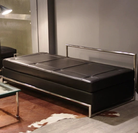 Modern black leather sofa with metal frame in a room setting