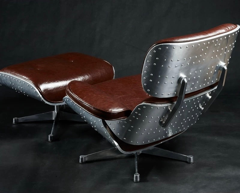 Modern lounge chair with ottoman on a dark background