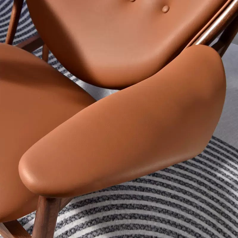 Close-up of a brown chair with a striped fabric background