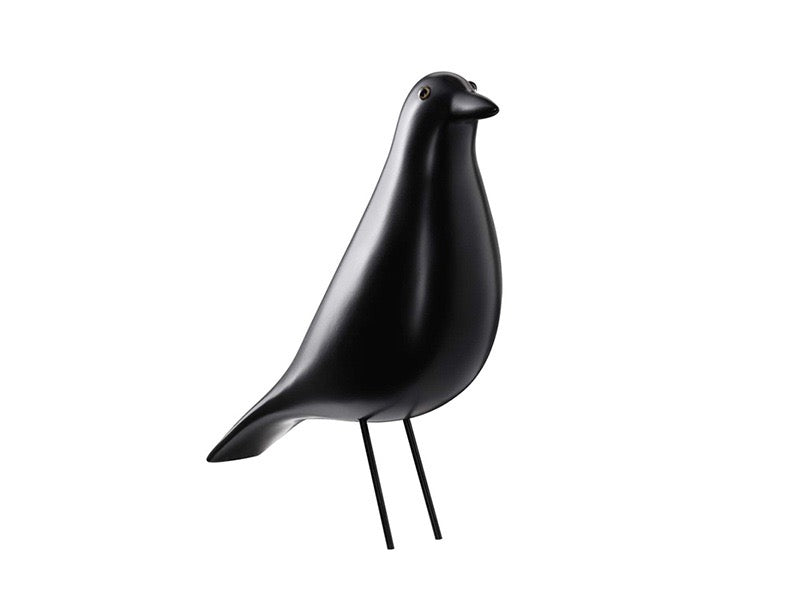 Black bird-shaped object on a white background