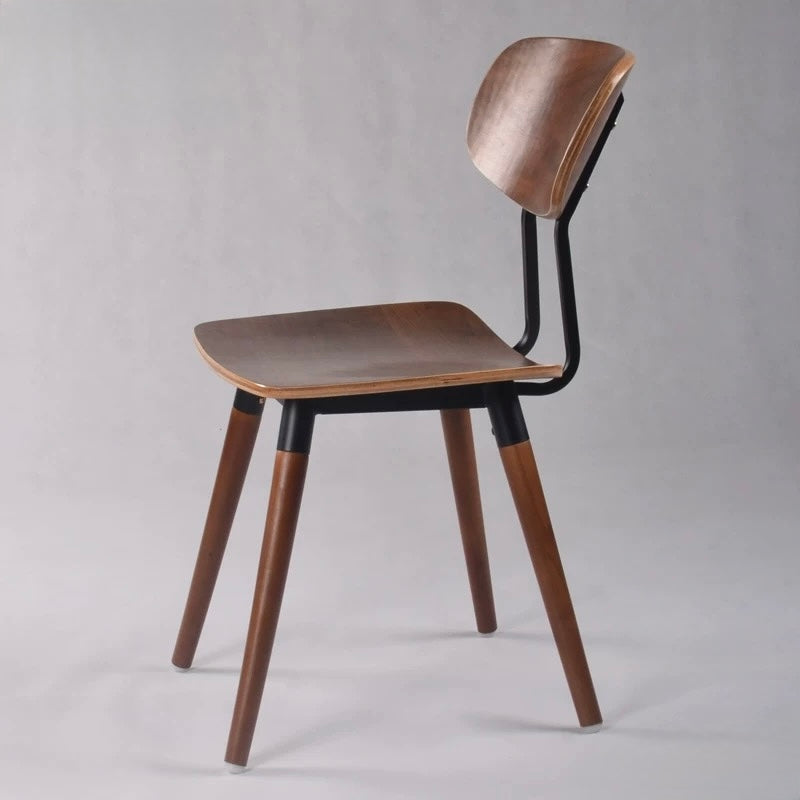 Wooden chair with a black frame on a gray background