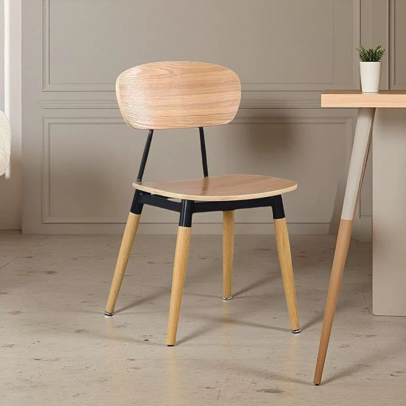 Wooden chair with black accents in a room setting