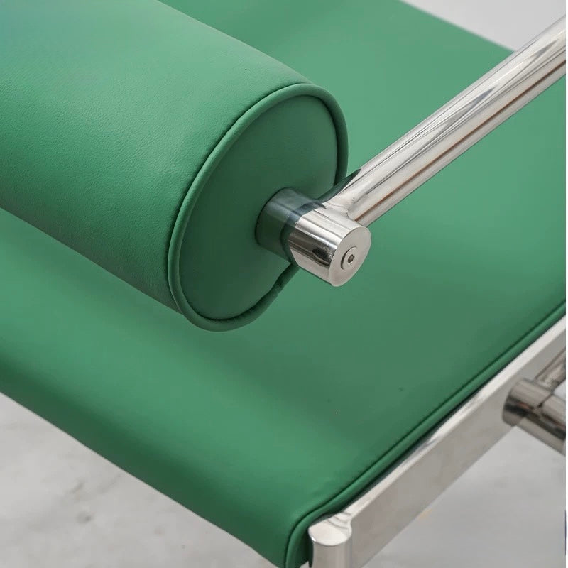 Green roller with metal handle on a light gray background