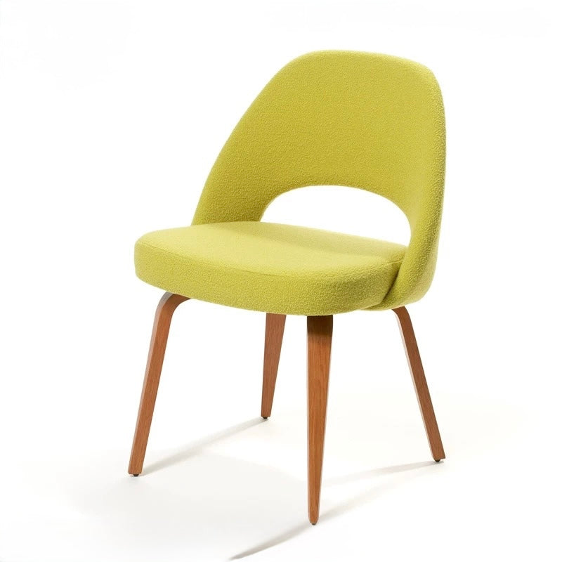 Green chair with wooden legs on a white background
