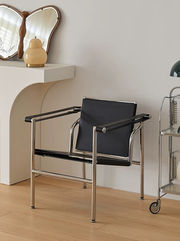 Modern black chair with metal frame in a minimalistic room.