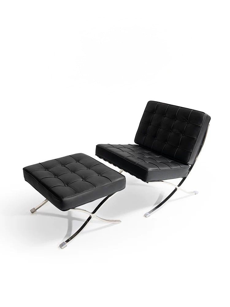 Black leather chair and ottoman on a white background