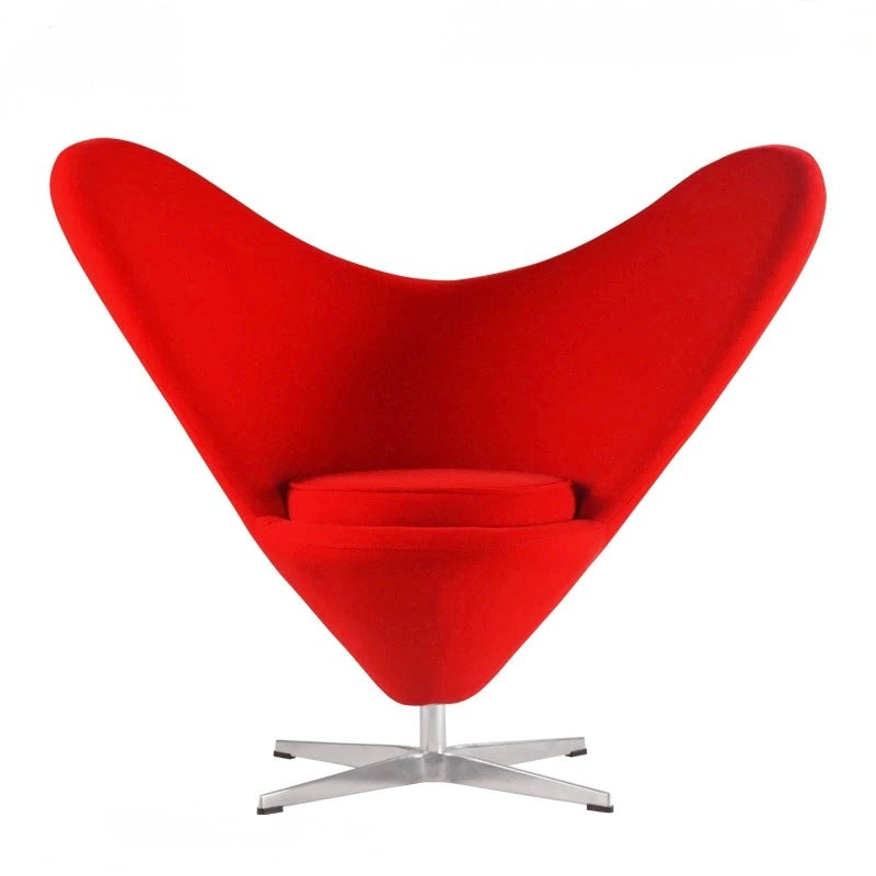 Red heart-shaped chair with a metal base on a white background