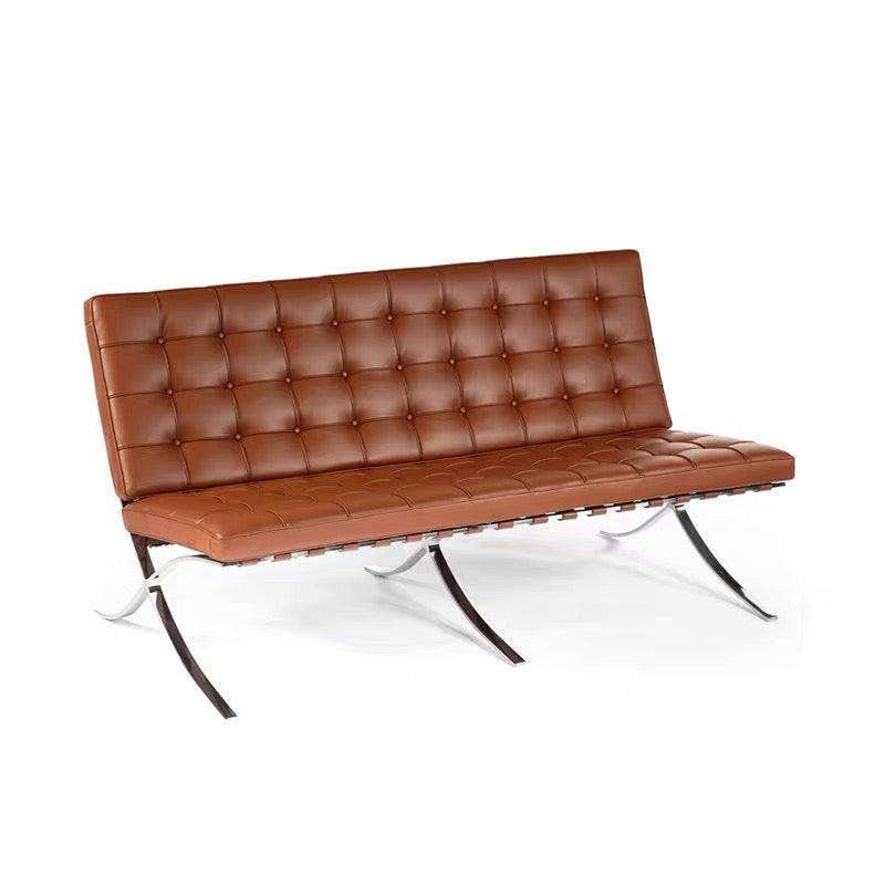 Brown leather sofa with metal legs on a white background