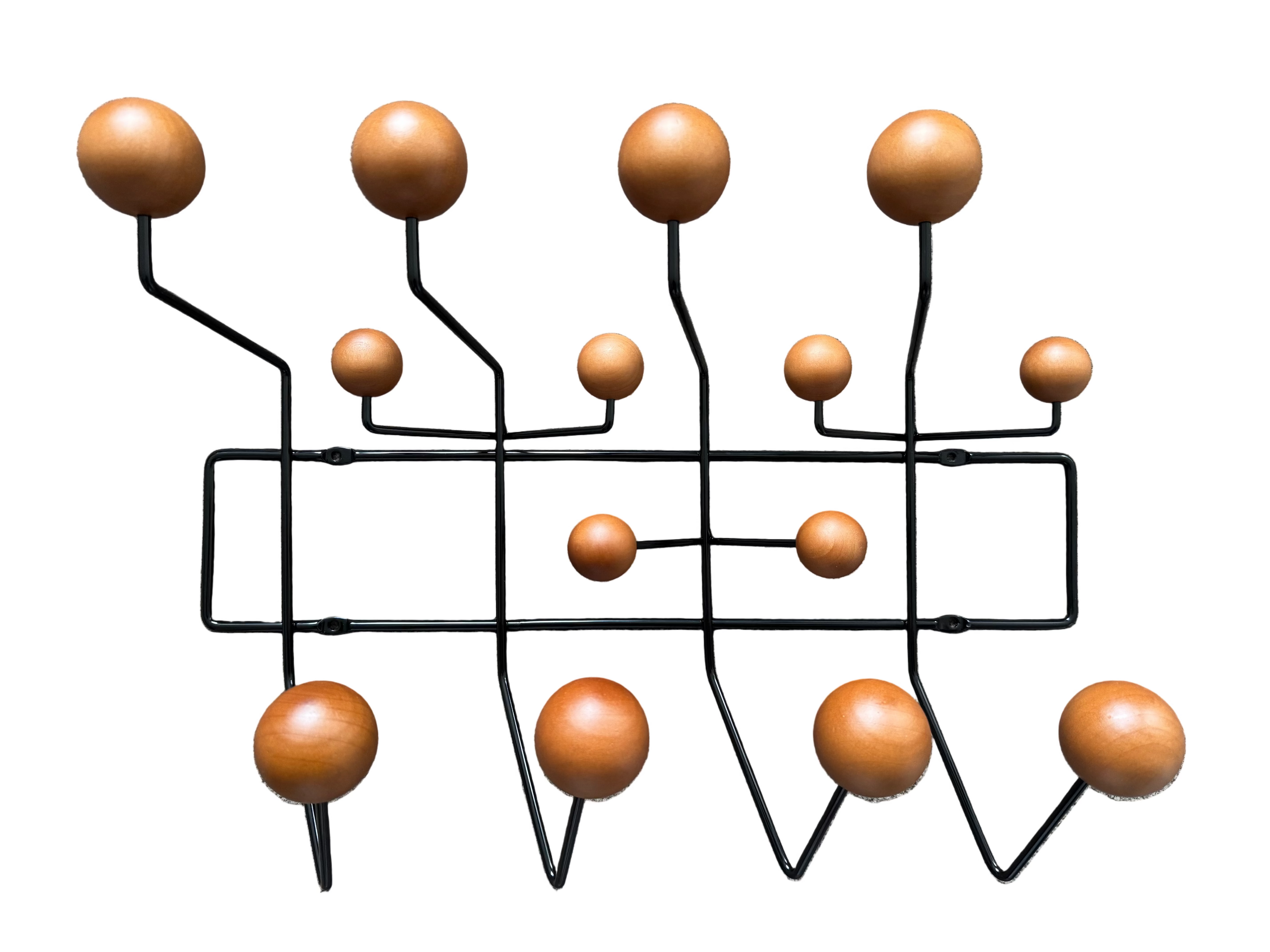 Wall-mounted coat rack with wooden balls on a white background