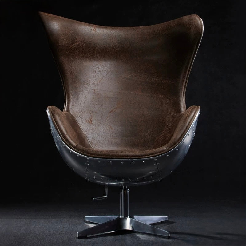 Brown leather chair with metal base on a dark background