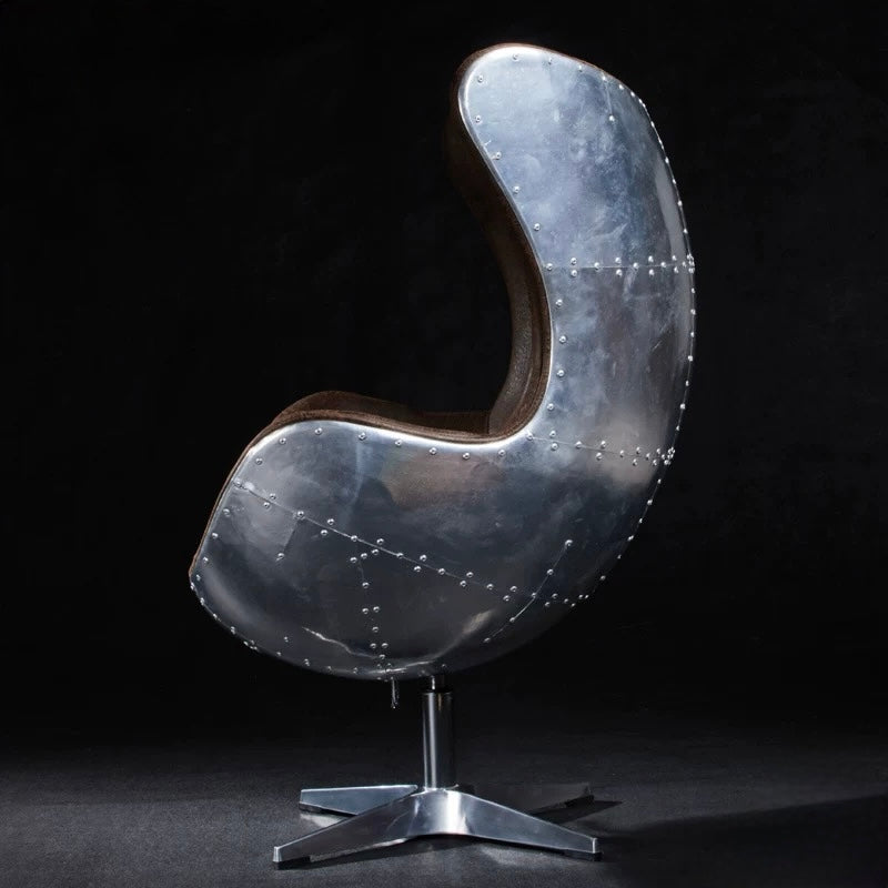 Modern chair with metallic finish on a black background
