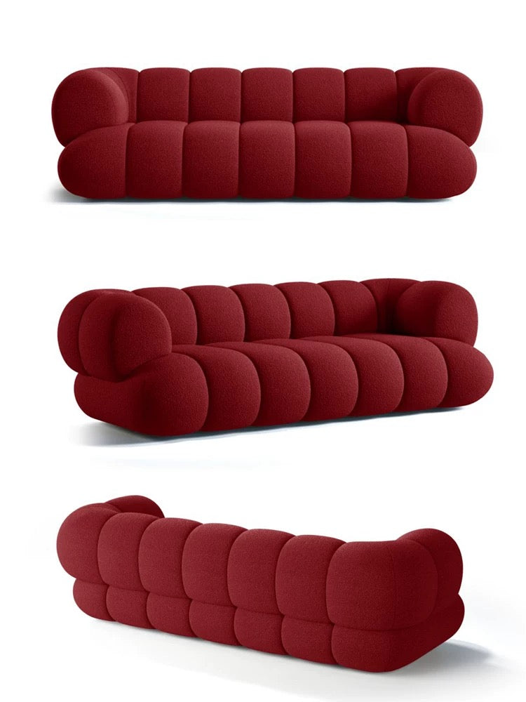 Red sofa with a modern design on a white background