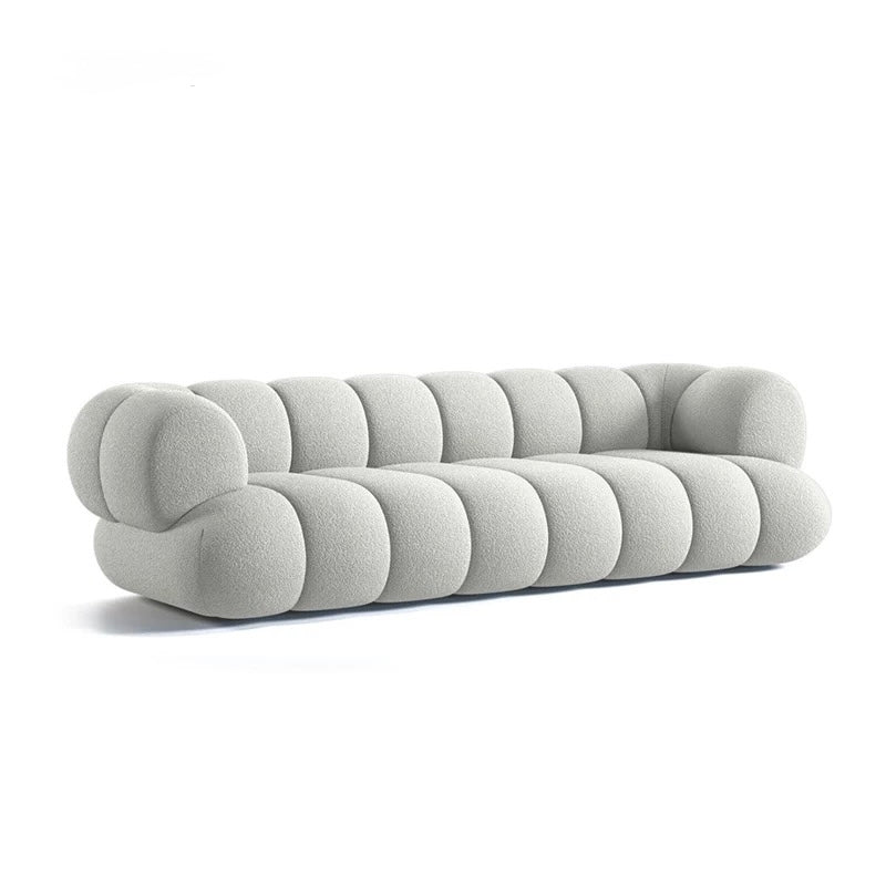 Gray sofa with rounded cushions on a white background