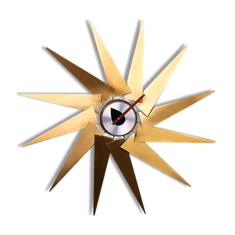 Decorative wall clock with starburst design on a white background